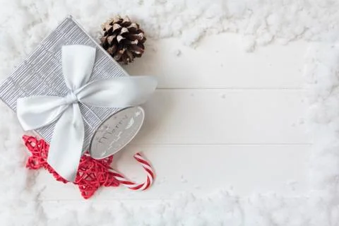 Top view of gift box and christmas decoration on white wooden table with snow Stock Photos