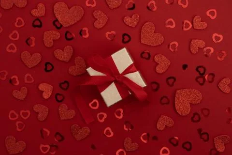 Top view of gift box on red background with confetti Stock Photos