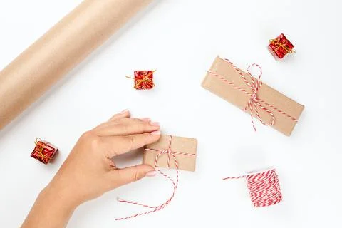 Top view of gift boxes packed in craft paper, the process of preparing for Stock Photos