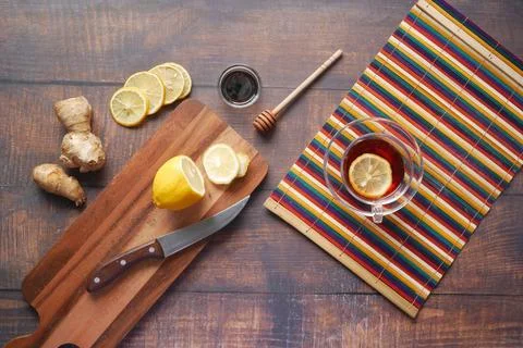 Top view of ginger and lemon tea on wooden background. Stock Photos
