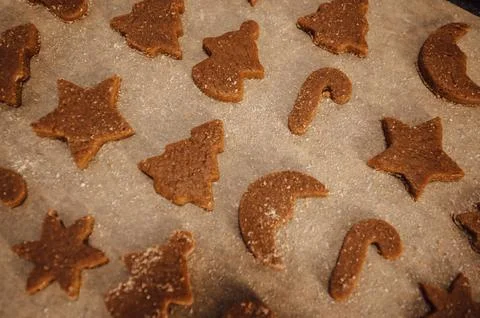 Top view Gingerbread cookies on baking tray in christmas shapes of tree,candy Stock Photos