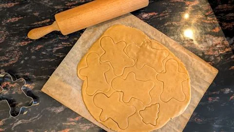 Top View of Gingerbread Man Cookie Dough with Metal Cutters Stock Photos