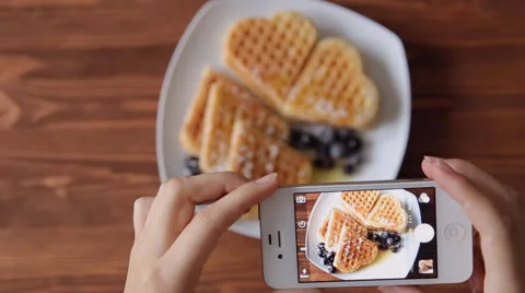Top view girl photographing breakfast using mobile phone Belgian waffles Stock Footage