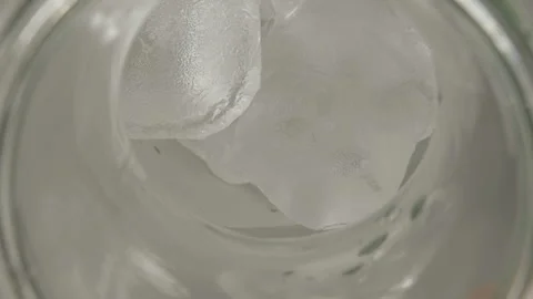 Top view of glass bottle with ice pouring pomegranate juice Stock Footage 104402029