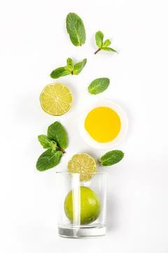 Top view of glass with lime, mint and honey on white background Stock-Fotos