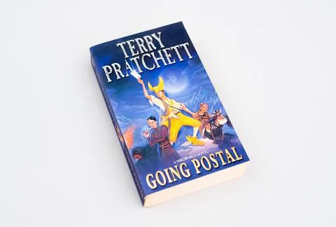 Top view of the "Going Postal" book by Terry Pratchett on a gray background Fotos de archivo