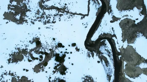 Top view going through a meandering river between snowy mountains Stock Footage 221835801