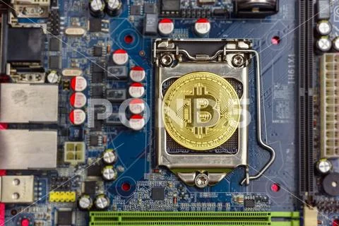 Top view of golden bit coin on computer mother board Stock Photos