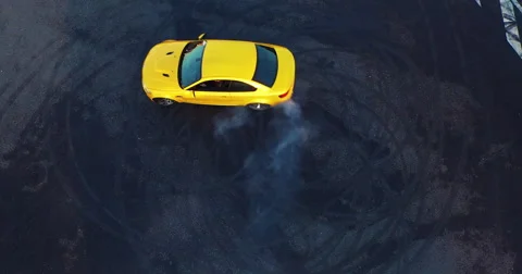 Top view of the golden car drifting on the road. Сar makes a few laps. Stock Footage