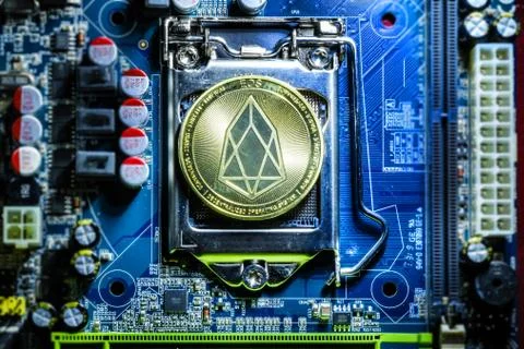 Top view of golden Eos cryptocurrency physical coin Stock Photos
