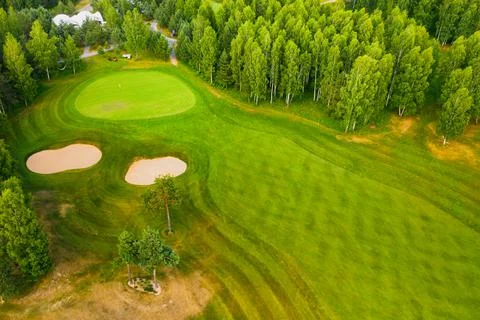 Top view of the golf course located in a wooded area Stock Photos