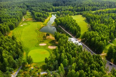 Top view of the golf course located in a wooded area Stock Photos