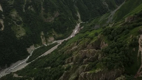 Top view on gorge between the mountains with trees and winding, narrow river. Stock Footage 106029451