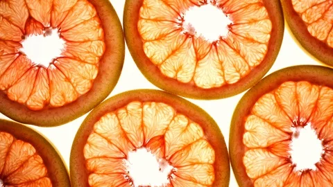 Top view of grape-fruit slices in flat lay close up, rotating contra clockwise Stock Footage 86430925