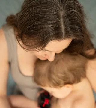 Top View of Gray-Haired Mother with Child on Lap Stock-Fotos