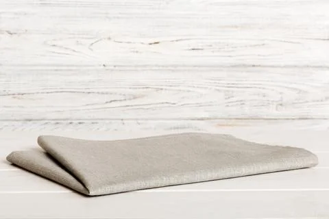 Top view with gray kitchen napkin isolated on table background. Folded clot.. Stock Photos
