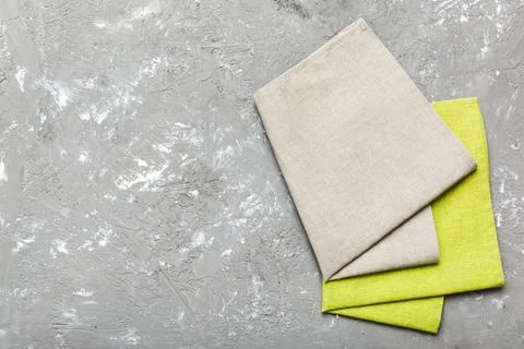 Top view with gray kitchen napkin isolated on table background. Folded cloth  Stock Photos