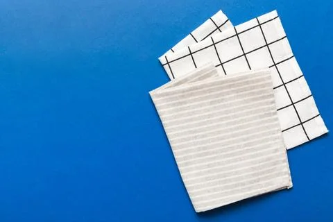 Top view with gray kitchen napkin isolated on table background. Folded cloth  Stock Photos