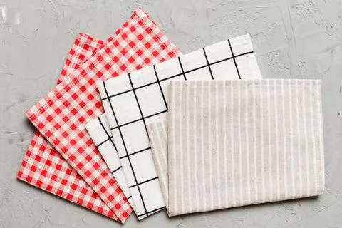 Top view with gray kitchen napkin isolated on table background. Folded clot.. Stock Photos