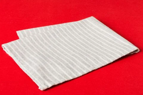 Top view with gray kitchen napkin isolated on table background. Folded cloth  Stock Photos