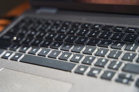Top view of a gray laptop keyboard on a wooden table Stock Photos