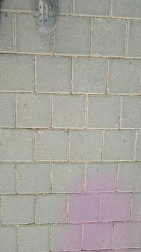Top view of gray square concrete paving blocks on a sidewalk with a person .. Fotos de archivo