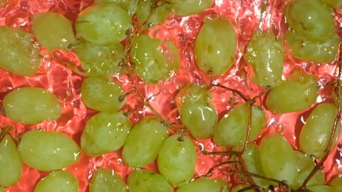 Top view of green grapes submerged in water with ripples vertical slow motion vi Stock Footage 345639655