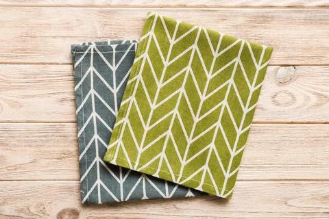 Top view with green kitchen napkin isolated on table background. Folded clo.. Stock Photos