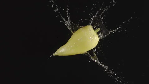 TOP VIEW: Green Pepper falls in a water, splashing - Slow motion Stock Footage 161688010