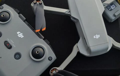 Top view of the grey DJI Mini 2 drone and remote above the bag and in nature Stock Photos
