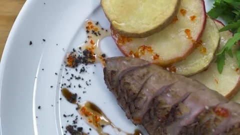 Top view grilled meat steak with fried potatoes on white plate close up. Food Stock Footage 104490656