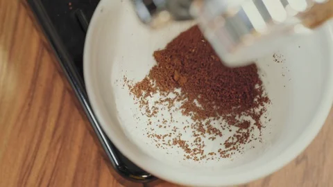 Top View of Ground Coffee Dispensing into a Cup Stock Footage 129303248