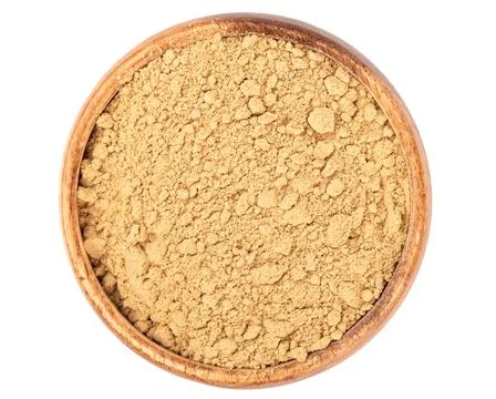 Top view of ground ginger root powder in a wooden bowl. Stock Photos