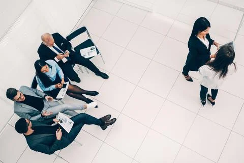 Top view. a group of employees using their devices in the workplace Stock Photos