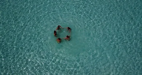 Top view of group of five young people handling hands on shallow turquoise 스톡 동영상 118243358