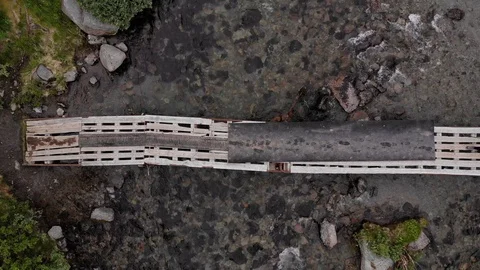 Top view of a group of hikers with large backpacks cross the bridge. Stock Footage 122216603