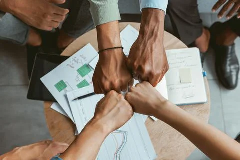 Top view of group multi ethnic coworkers stacked hands together as concept of Stock Photos