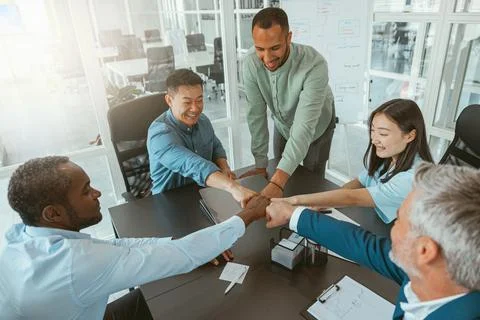 Top view of group multi ethnic coworkers stacked hands together as concept of Stock Photos