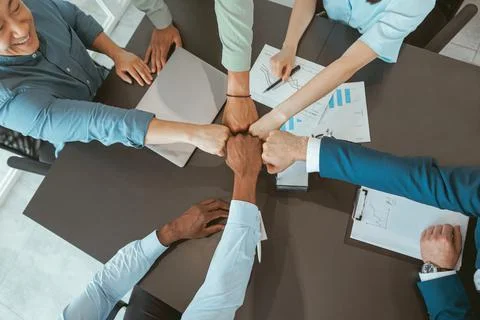 Top view of group multi ethnic coworkers stacked hands together as concept of Stock Photos