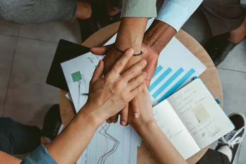 Top view of group multi ethnic coworkers stacked hands together as concept of Stock Photos