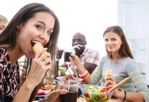 Top view of group of people having dinner together while sitting at wooden table Stock Photos