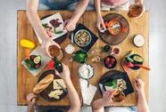 Top View, Group Of People Sitting At The Table With Food, Enjoying A Drink Stock Photos