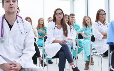Top view. a group of smiling doctors pointing at you. Stock Photos