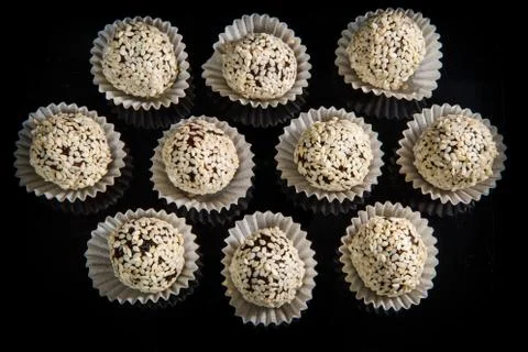 Top view on group of useful round handmade candies with sesame seeds 스톡 사진