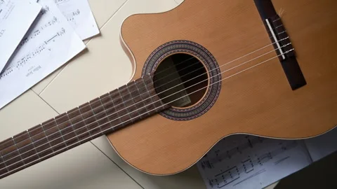 Top view , guitar spinning , notes on table, classical guitar music Video stock 304028433