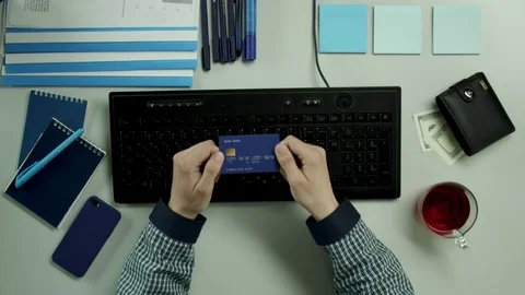 Top view of a guy using his credit card in an internet store Stock Footage 79987315