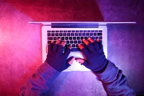 Top view of hacker hand stealing data from laptop Stock Photos