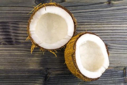 Top view of Half cut coconut on a rustic wooden table Stock Photos