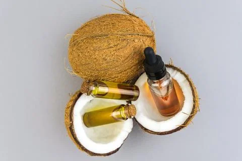 Top view of Half cut coconuts with Coconut essential oils in glass bottles is Stock Photos