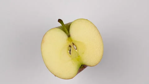Top View Half Fresh Apple Rotating On White Background Studio Shot 4K Stock-Footage 321884426